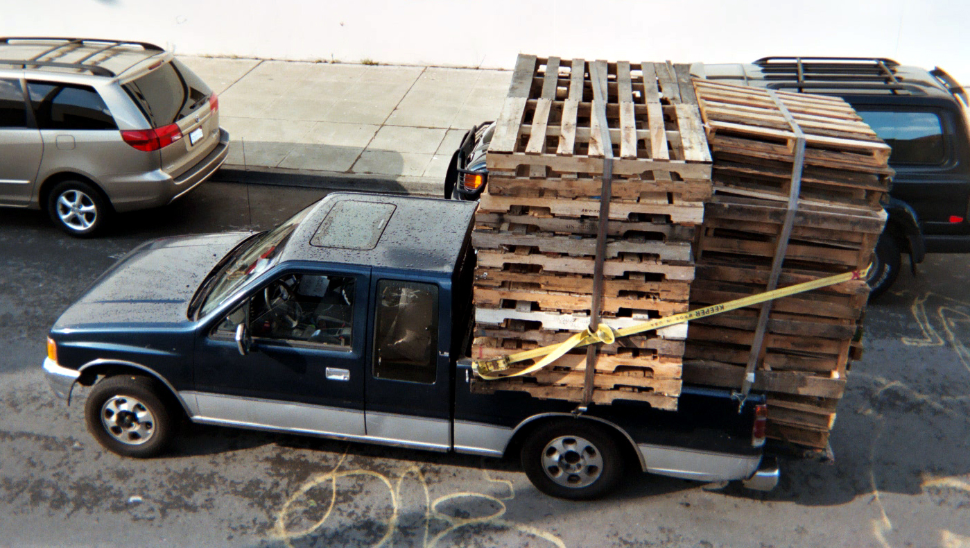 pick up truck with pallets in bed of truck 